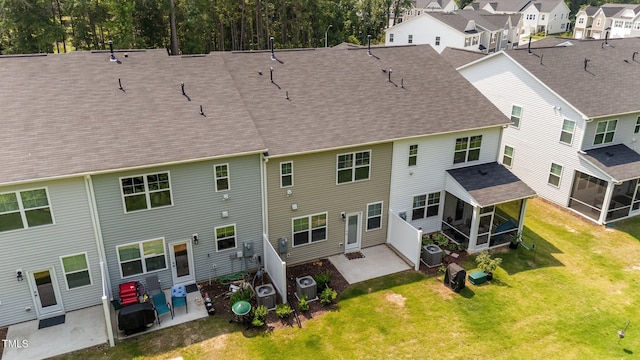156 Velvet Ridge Way, Garner, NC 27529 - rear view of property featuring a sunroom, a patio, a shingled roof, a yard, and a residential view