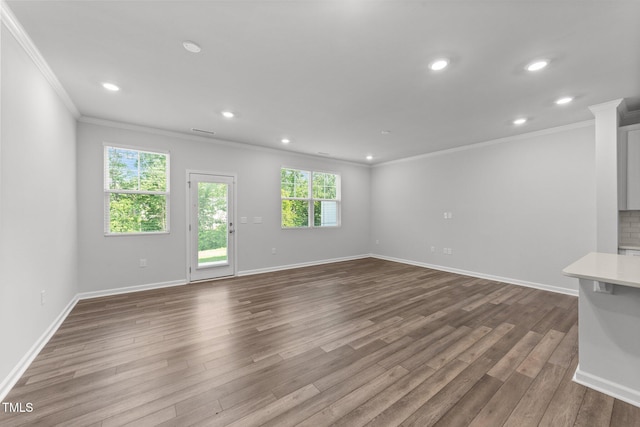 156 Velvet Ridge Way, Garner, NC 27529 - unfurnished living room with ornamental molding, dark wood-style flooring, and recessed lighting