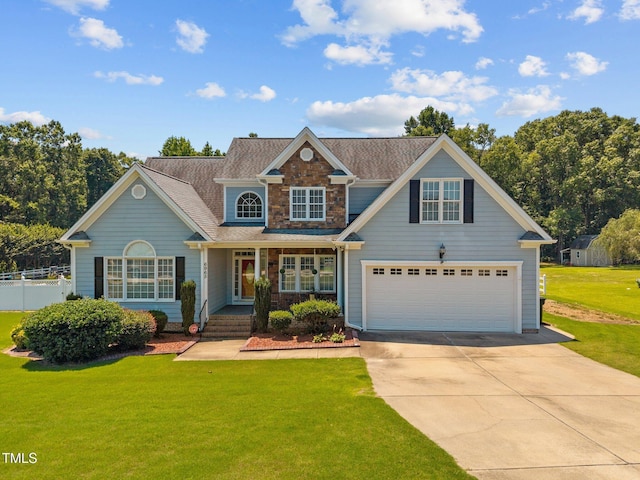 6965 Ogburn Farms Dr, Willow Springs, NC 27592 - view of front of home featuring concrete driveway, covered porch, and stone siding