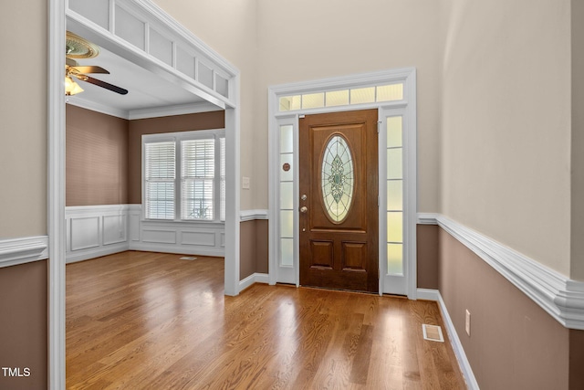 6965 Ogburn Farms Dr, Willow Springs, NC 27592 - foyer entrance with a ceiling fan, crown molding, wainscoting, and wood finished floors