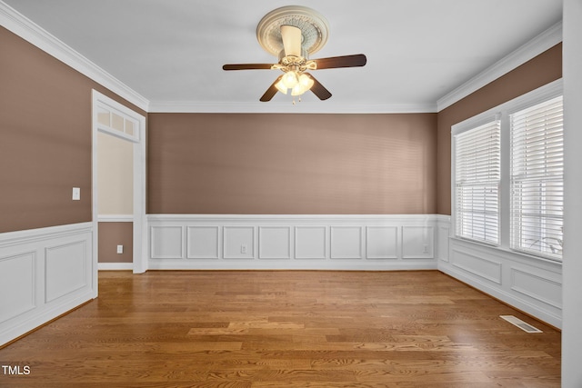6965 Ogburn Farms Dr, Willow Springs, NC 27592 - empty room with a ceiling fan, light wood-style flooring, wainscoting, and ornamental molding
