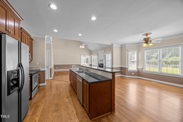 6965 Ogburn Farms Dr, Willow Springs, NC 27592 - kitchen featuring stainless steel appliances, a ceiling fan, light wood-style flooring, an island with sink, and ornamental molding