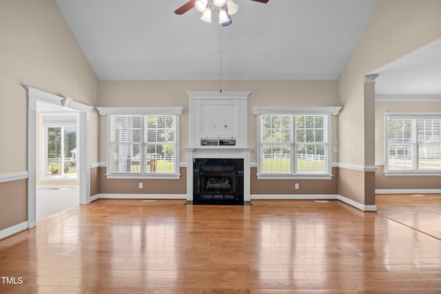 6965 Ogburn Farms Dr, Willow Springs, NC 27592 - unfurnished living room featuring vaulted ceiling, a ceiling fan, light wood finished floors, and a fireplace with flush hearth