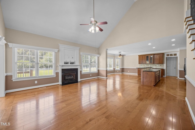 6965 Ogburn Farms Dr, Willow Springs, NC 27592 - unfurnished living room with ceiling fan, a fireplace with flush hearth, light wood-style floors, high vaulted ceiling, and recessed lighting