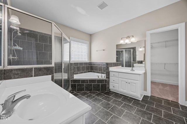 6965 Ogburn Farms Dr, Willow Springs, NC 27592 - full bath featuring two vanities, a stall shower, a bath, tile patterned floors, and a spacious closet