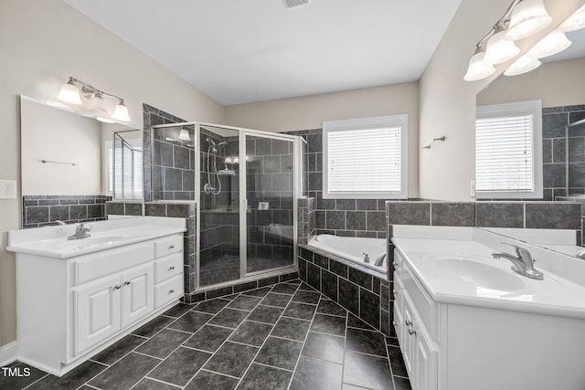 6965 Ogburn Farms Dr, Willow Springs, NC 27592 - full bathroom featuring two vanities, a shower stall, a bath, healthy amount of natural light, and tile walls