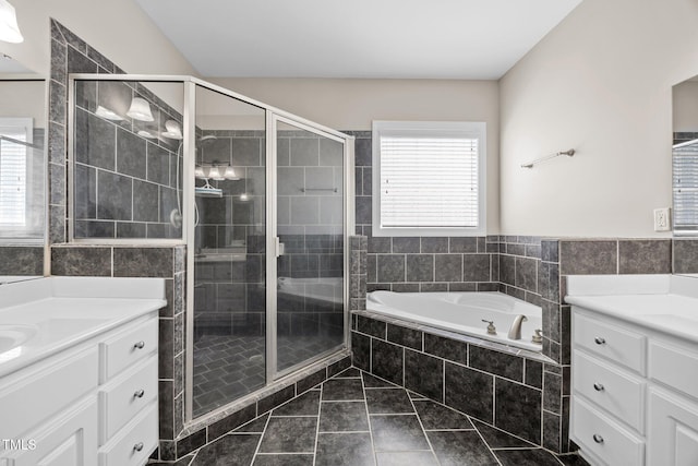 6965 Ogburn Farms Dr, Willow Springs, NC 27592 - bathroom with vanity, a shower stall, a garden tub, marble look tile flooring, and tile walls