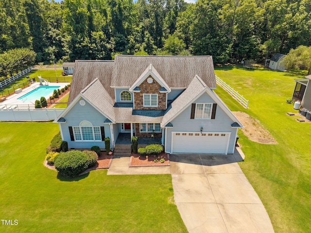 6965 Ogburn Farms Dr, Willow Springs, NC 27592 - view of front of home with concrete driveway, stone siding, and roof with shingles