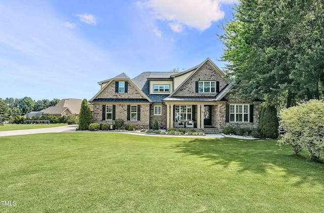 39 Wood Stork Ct, Clayton, NC 27520 - view of front of house with a porch, a front lawn, and brick siding