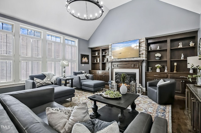 39 Wood Stork Ct, Clayton, NC 27520 - living area with high vaulted ceiling, a chandelier, wood finished floors, and a warm lit fireplace