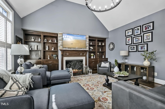 39 Wood Stork Ct, Clayton, NC 27520 - living area with high vaulted ceiling, a lit fireplace, and a chandelier