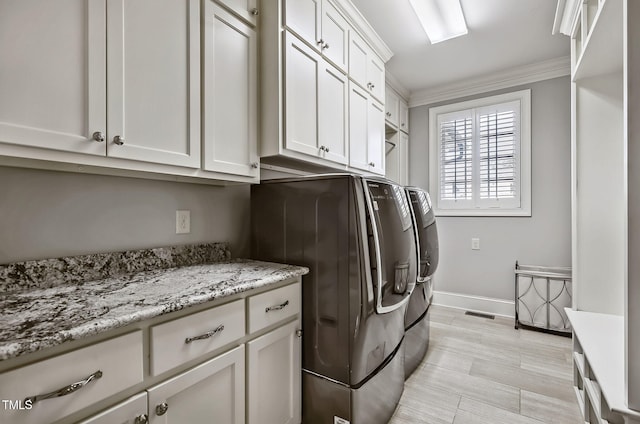 39 Wood Stork Ct, Clayton, NC 27520 - laundry area with washing machine and dryer, ornamental molding, and cabinet space