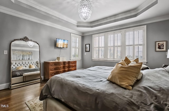 39 Wood Stork Ct, Clayton, NC 27520 - bedroom featuring a chandelier, wood finished floors, ornamental molding, and a raised ceiling