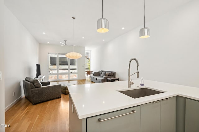 402 Chavis Way, Raleigh, NC 27601 - kitchen with gray cabinetry, open floor plan, light wood-style flooring, light countertops, and recessed lighting