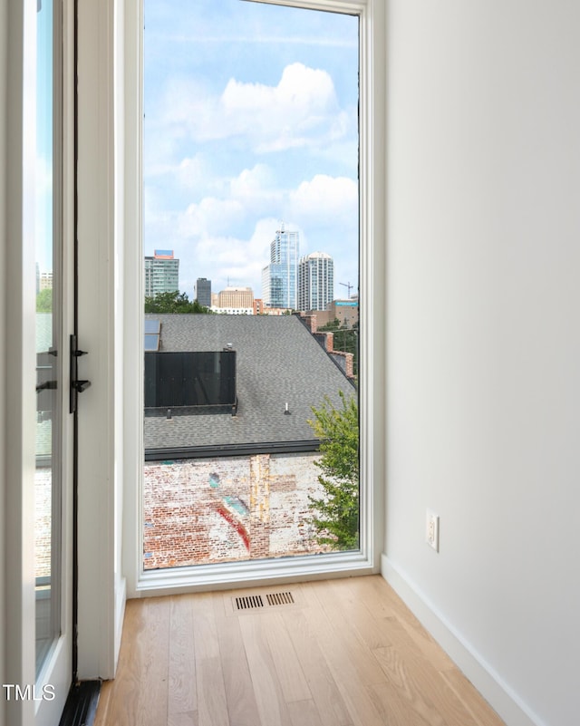 402 Chavis Way, Raleigh, NC 27601 - unfurnished room featuring wood finished floors and a city view