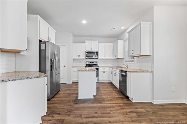 399 Springhaven Dr, Raeford, NC 28376 - kitchen with stainless steel appliances, tasteful backsplash, white cabinetry, dark wood finished floors, and recessed lighting