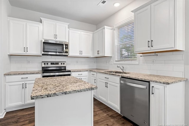 399 Springhaven Dr, Raeford, NC 28376 - kitchen featuring stainless steel appliances, white cabinets, dark wood-style floors, a kitchen island, and recessed lighting