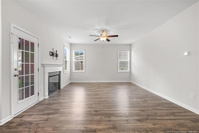 399 Springhaven Dr, Raeford, NC 28376 - unfurnished living room with ceiling fan, a glass covered fireplace, and dark wood finished floors