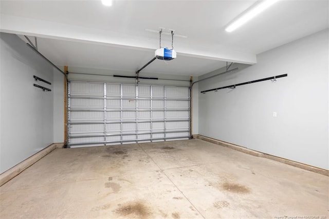 399 Springhaven Dr, Raeford, NC 28376 - garage featuring a garage door opener and baseboards
