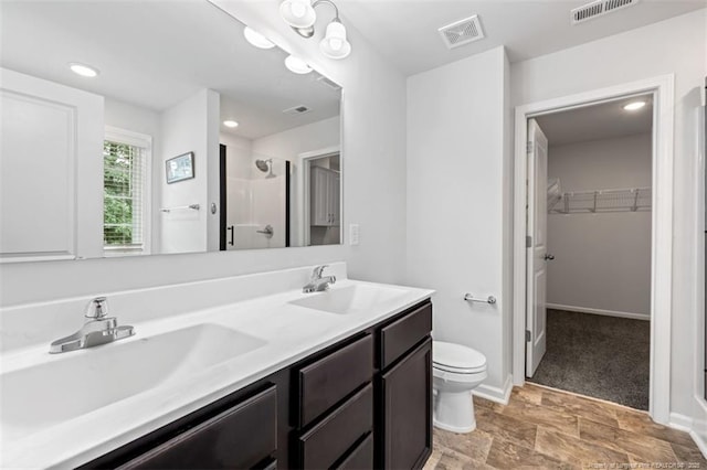 399 Springhaven Dr, Raeford, NC 28376 - full bathroom with a stall shower, a walk in closet, and double vanity