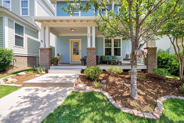 322 Tobacco Farm Way, Chapel Hill, NC 27516 - property entrance with a porch and brick siding