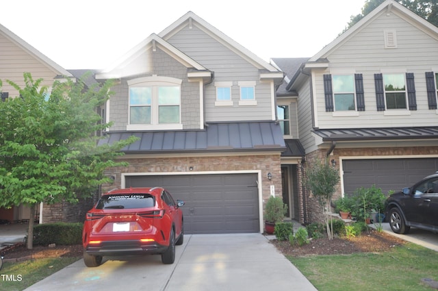 536 Rockcastle Dr, Cary, NC 27519 - view of property featuring a standing seam roof, an attached garage, concrete driveway, and a metal roof