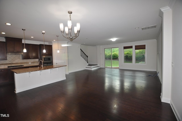 536 Rockcastle Dr, Cary, NC 27519 - unfurnished living room featuring ornamental molding, dark wood finished floors, recessed lighting, a chandelier, and stairway