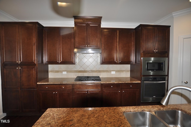 536 Rockcastle Dr, Cary, NC 27519 - kitchen featuring appliances with stainless steel finishes, stone counters, backsplash, under cabinet range hood, and crown molding