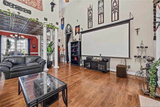 115 Race Ct, Godwin, NC 28344 - living area with ornate columns, a chandelier, wood finished floors, and a towering ceiling