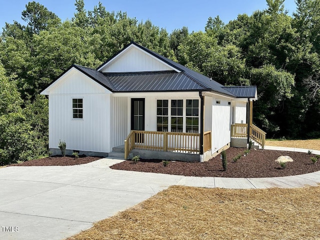 205 Gentry St, Roxboro, NC 27573 - modern farmhouse with a metal roof and a porch