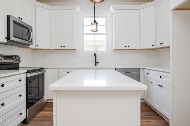 205 Gentry St, Roxboro, NC 27573 - kitchen with stainless steel appliances, decorative backsplash, and wood finished floors