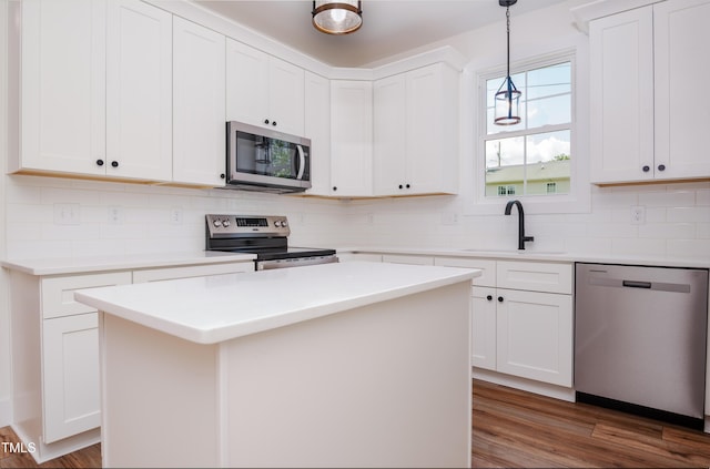 205 Gentry St, Roxboro, NC 27573 - kitchen featuring stainless steel appliances, tasteful backsplash, hanging light fixtures, light countertops, and white cabinets