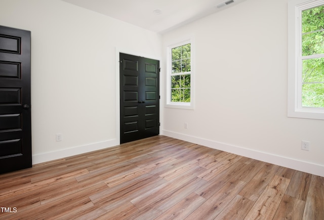 205 Gentry St, Roxboro, NC 27573 - empty room with light wood-type flooring and plenty of natural light