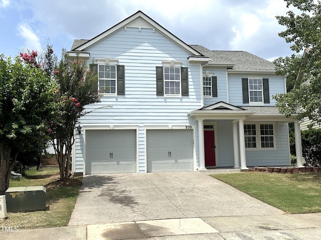 205 Bog Hill Ln, Cary, NC 27519 - traditional home with an attached garage, driveway, and a shingled roof