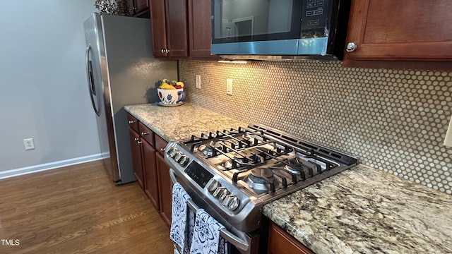 205 Bog Hill Ln, Cary, NC 27519 - kitchen featuring appliances with stainless steel finishes, backsplash, wood finished floors, and light stone counters