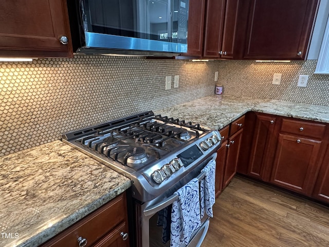 205 Bog Hill Ln, Cary, NC 27519 - kitchen featuring appliances with stainless steel finishes, wood finished floors, backsplash, and light stone countertops