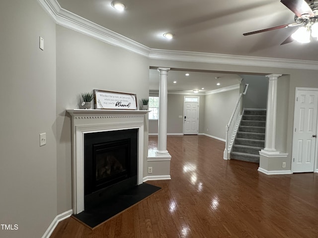 205 Bog Hill Ln, Cary, NC 27519 - unfurnished living room featuring ornamental molding, ceiling fan, decorative columns, wood finished floors, and a fireplace with flush hearth