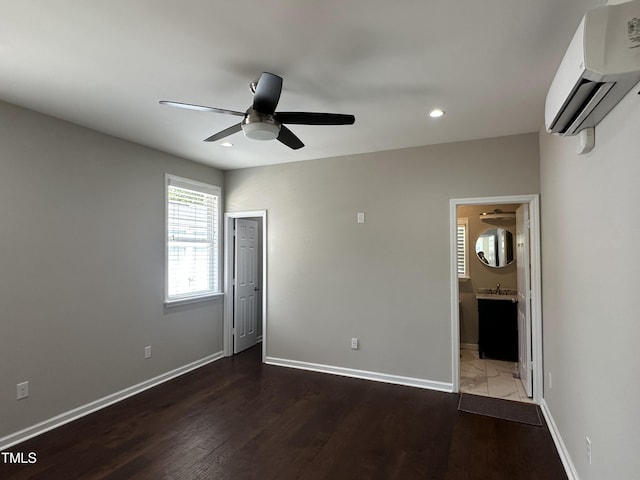 205 Bog Hill Ln, Cary, NC 27519 - unfurnished bedroom featuring a wall mounted air conditioner, recessed lighting, wood finished floors, ensuite bathroom, and a ceiling fan