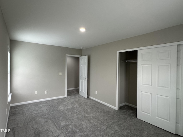 205 Bog Hill Ln, Cary, NC 27519 - unfurnished bedroom featuring dark carpet and a closet