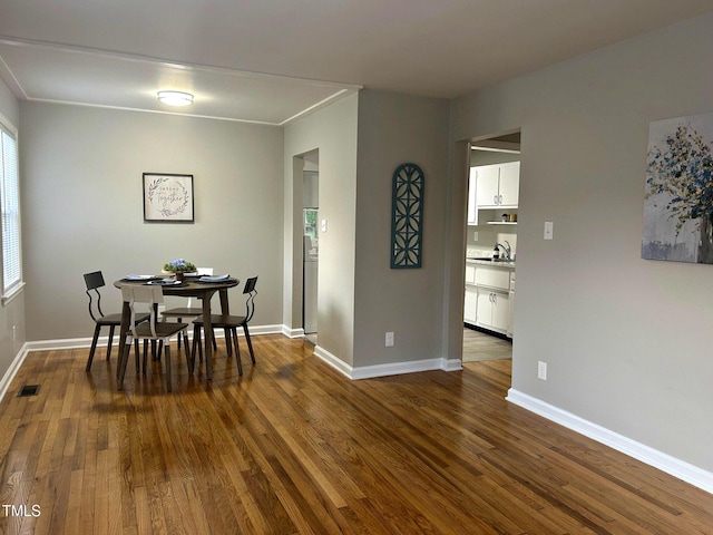 2331 Kennington Rd, Raleigh, NC 27610 - dining room featuring dark wood-type flooring and baseboards