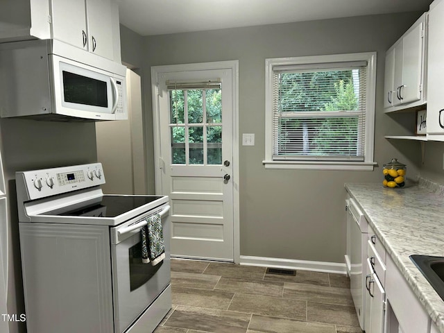 2331 Kennington Rd, Raleigh, NC 27610 - kitchen featuring white appliances, light countertops, and white cabinets