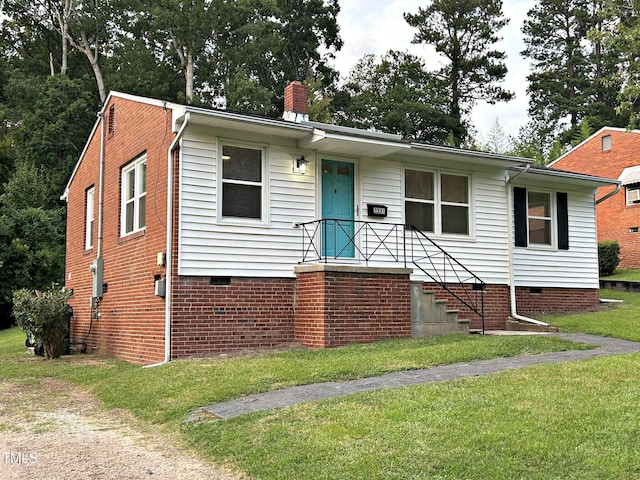 2331 Kennington Rd, Raleigh, NC 27610 - view of front of house with crawl space, a front yard, and a chimney