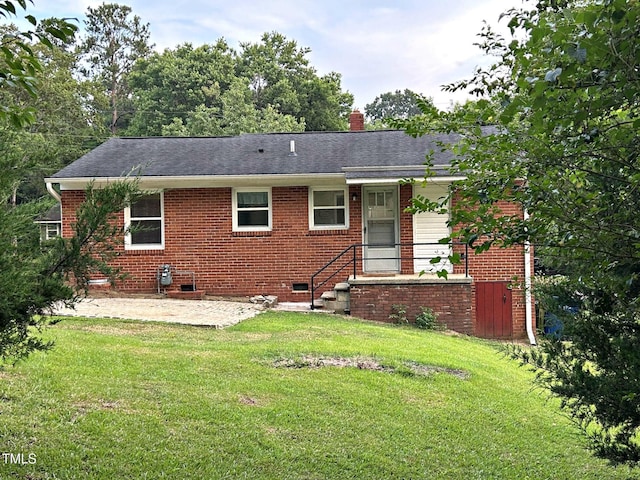 2331 Kennington Rd, Raleigh, NC 27610 - rear view of property featuring a lawn, brick siding, a patio area, and crawl space