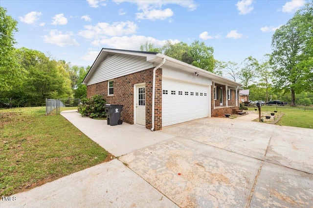 410 W Tenth St, Siler City, NC 27344 - view of side of property with brick siding, driveway, and an attached garage
