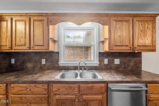 410 W Tenth St, Siler City, NC 27344 - kitchen with stainless steel dishwasher, dark countertops, and brown cabinets