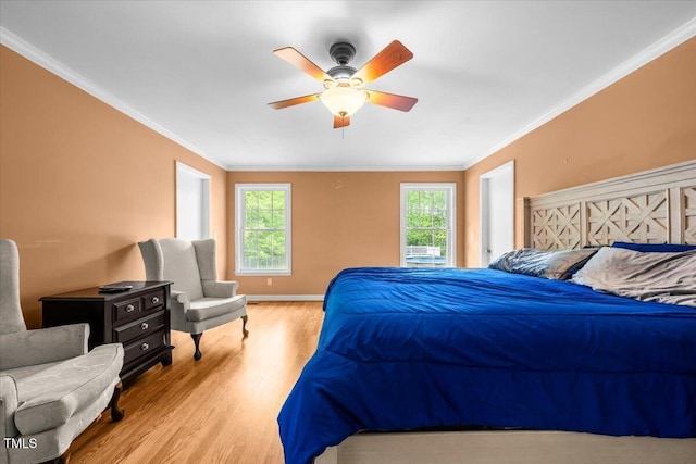 410 W Tenth St, Siler City, NC 27344 - bedroom with wood finished floors, multiple windows, ornamental molding, and ceiling fan
