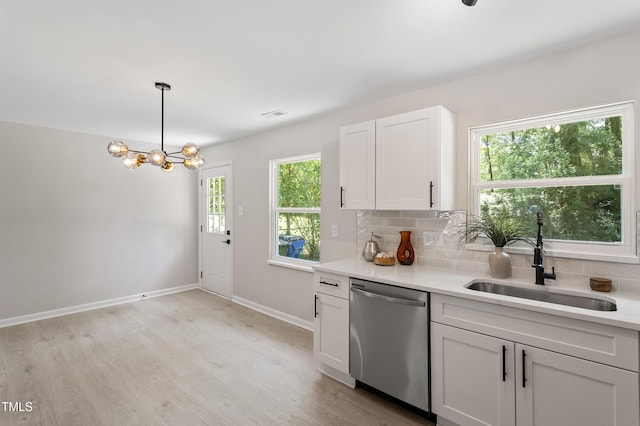 768 Lunar Dr, Raleigh, NC 27610 - kitchen with dishwasher, tasteful backsplash, light countertops, a chandelier, and light wood finished floors