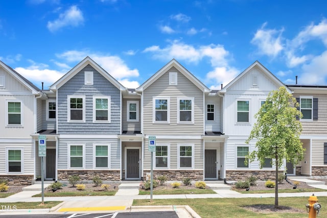 4949 Microcline Trl, Raleigh, NC 27610 - townhome / multi-family property featuring stone siding, board and batten siding, and uncovered parking