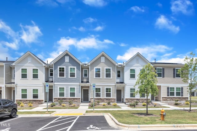4949 Microcline Trl, Raleigh, NC 27610 - townhome / multi-family property with stone siding, board and batten siding, and uncovered parking