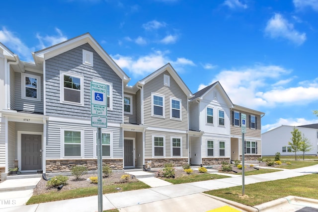 4949 Microcline Trl, Raleigh, NC 27610 - townhome / multi-family property with stone siding and a residential view
